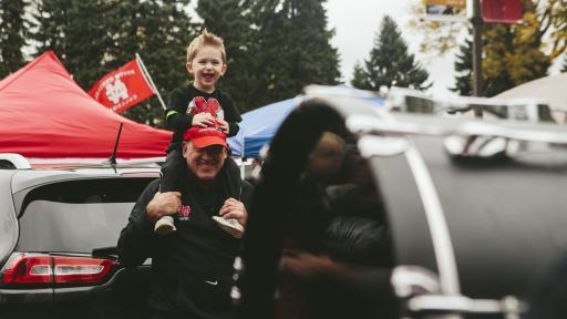 Father and son at homecoming football tailgate